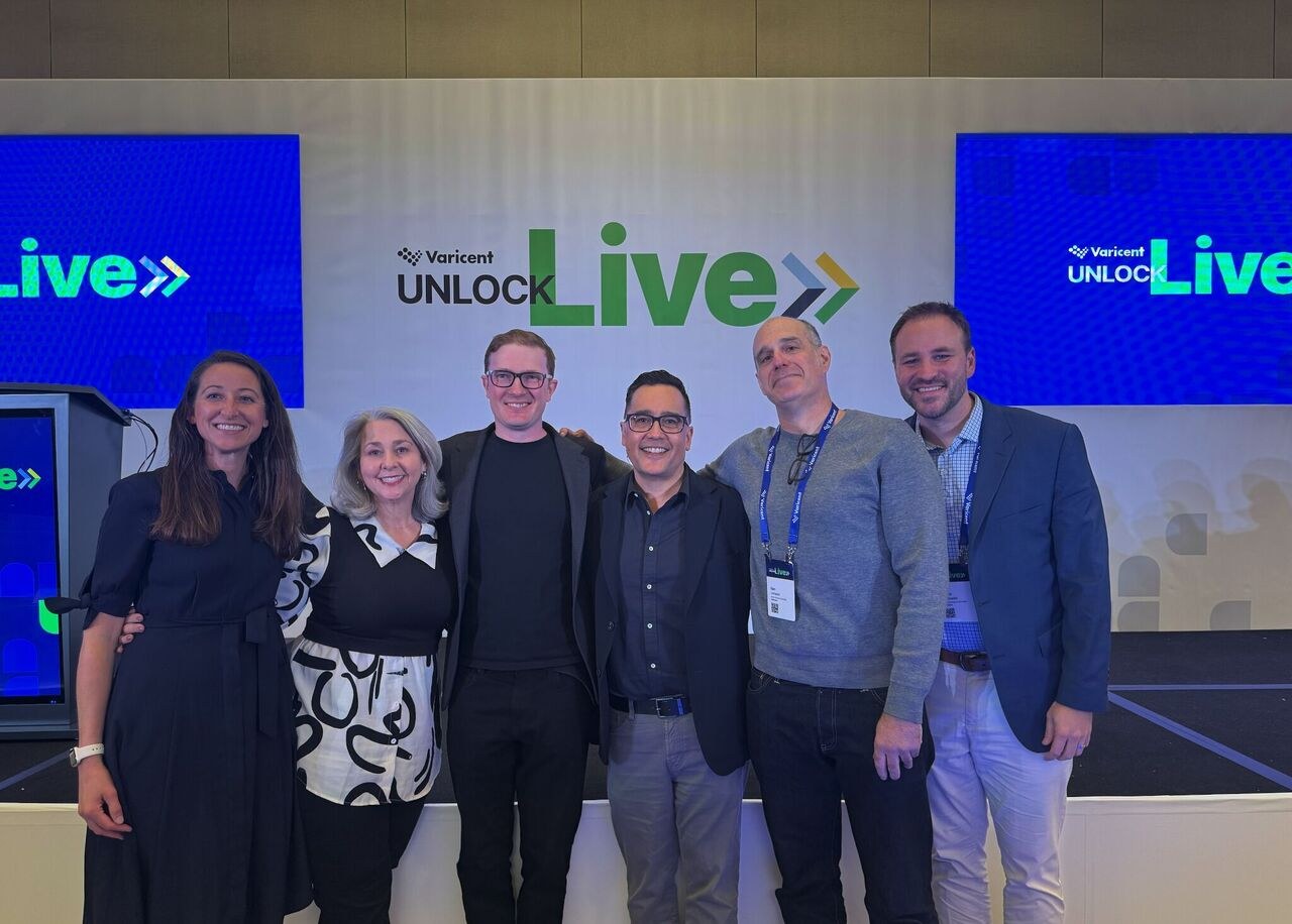 Henry with the Varicent Unlock team at the Live backdrop